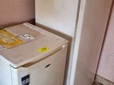 a refrigerator and a refrigerator freezer in the corner of a room