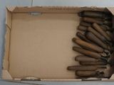 a cardboard box with a bunch of wooden handles in it