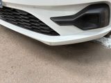 the front bumper of a white car with a blue stripe on it