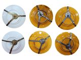 four yellow plates with keys on them are sitting on a white surface