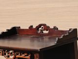 a small wooden table with a drawer on it