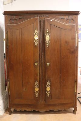 a wooden armoire with gold decorations on it