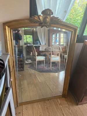 a large mirror in the corner of a room