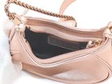 a pink purse with a gold chain hanging from it
