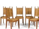 four wooden chairs with wicker seats and a cane back