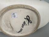 a white vase with black writing on it on a table