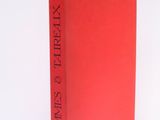 the red book is sitting on a white surface