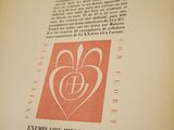 an open book with a picture of a heart on it