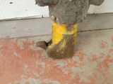 a fire hydrant that has been painted yellow and gray