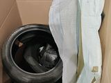 a box with a tire inside of it with a sheet over it