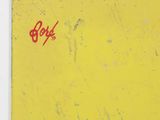 a picture of a yellow sign with a red spray painted on it