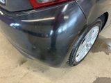 a close up of a car ' s rear end with a dirty paint job