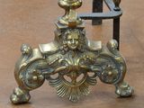 a gold vase sitting on top of a metal stand