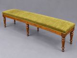 an image of a bench with a green upholstered seat