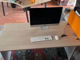 a desk with a computer and a keyboard on it