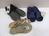 two pairs of sandals and a pair of flip flops on a table