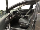 the interior of a car with the door open and the driver ' s seat down