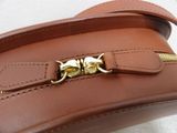 a brown leather bag with a gold clasp on it