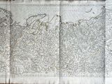 une vieille carte du monde dessinée sur une feuille de papier posée sur une table