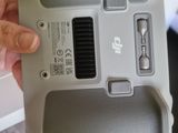 a person holding a small device in their hand