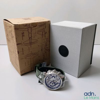 a watch sitting next to a box with a watch in it