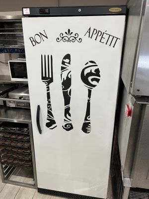 a refrigerator with a sign that says bon bon appetit on it