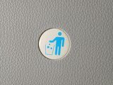 a blue and white sticker with a man in a trash can