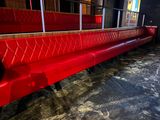 a red bench in the middle of a room