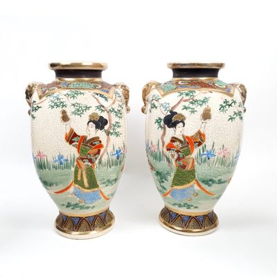 pair of asian vases with asian women on them on a white background