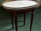 a table with a marble top on it in a room