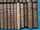 many old books in a blue crate on the table