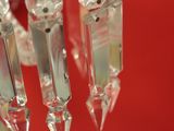 a close up view of a crystal chandelier hanging from a red wall