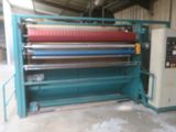 an image of a machine that is working on a piece of fabric
