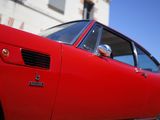 a red car that is parked in front of a building