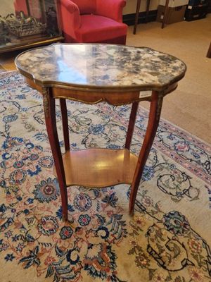 a small table with a marble top in a living room