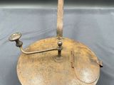 an old brass plate with a handle on a table