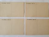 four pieces of brown paper with black writing on them sitting on a table
