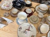 a table with a lot of dishes and cups on it