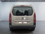 citroen van parked in a showroom with two people in the back seat