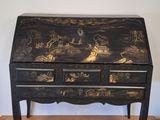black and gold painted desk with drawers and drawers on top of it