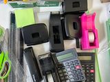 a desk with a calculator, pencils, and other office supplies on it