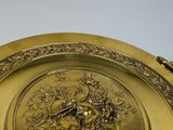 a gold plate with a picture of a bird on it