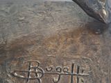 a bronze statue of a horse with a name written on it