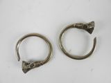 two silver rings with a snake head on them on a white surface
