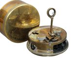 a small clock that is sitting on top of a table
