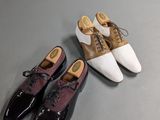 two pairs of shoes sitting on top of a table next to each other