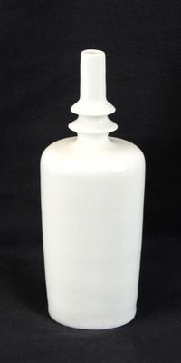 a white bottle that is sitting on a black background