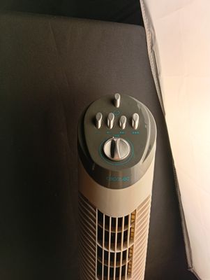 a small air conditioner sitting on the floor next to a wall