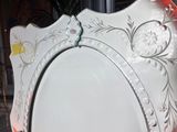 a white plate on a stand with an orange border