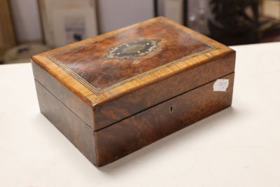 a small wooden box on a table with a clock on it
